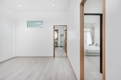 an empty room with a mirror and a bedroom at Haus Ekkamai 2 in Khlong Toei