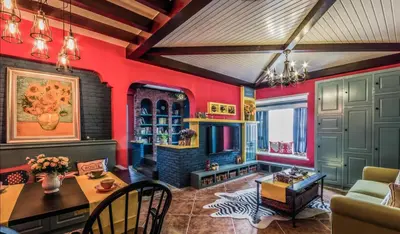 a living room with red walls and a table at Manmanlovehome in Bangkok