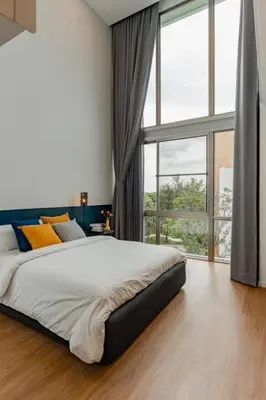 a bedroom with a large bed and a large window at \u8c6a\u534e\u522b\u5885\u7231\u4e4b\u5bb6Apao in Bangkok