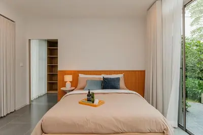 a bedroom with a bed and a large window at \u8c6a\u534e\u522b\u5885\u7231\u4e4b\u5bb6Apao in Bangkok