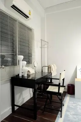 a black table and a chair in a room at Nap by Snooze in Bangkok