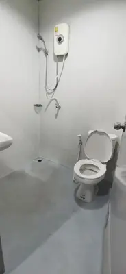 a white bathroom with a toilet and a sink at XX GO INN Khaosan road The Grand Palace โกอินน์ ถนนข้าวสาร กรุงเทพมหานคร in Bangkok