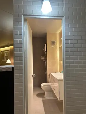 a bathroom with a toilet and a sink and a light at ห้องพักเมืองทองธานี Happiness sleep C4 in Ban Bang Phang