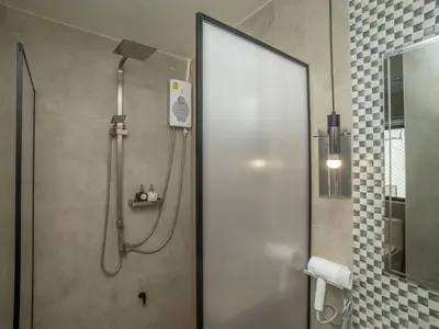 a shower in a bathroom with a glass door at Cozy studio room for 3 guests at Center-Silom - 5B in Bang Rak