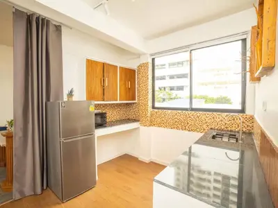 a kitchen with a stainless steel refrigerator and a window at 2-Bedroom Penthouse in the heart of Silom - 4A in Bang Rak