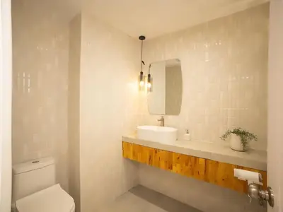 a bathroom with a sink and a toilet and a mirror at 2-Bedroom apartment for 4 guests, Center-Silom - 3A in Bang Rak