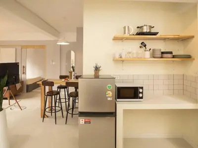 a kitchen with a refrigerator and a table with chairs at 2-Bedroom apartment for 4 guests, Center-Silom - 3A in Bang Rak
