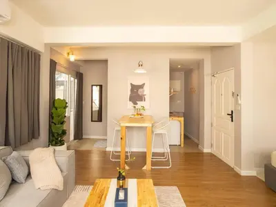 a living room with a couch and a table at Cozy studio for 3 guests in the heart of Silom - 3B in Bang Rak