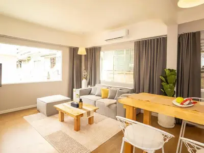 a living room with a couch and a table at Cozy studio for 3 guests in the heart of Silom - 3B in Bang Rak