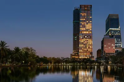 a city skyline at night with a river and buildings at The Ritz-Carlton, Bangkok in Bangkok