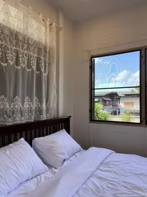 a bedroom with a bed and a window at Thairin House Old town BKK in Dusit