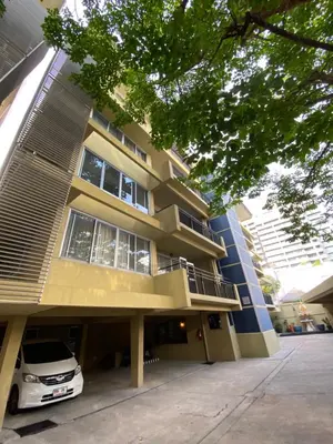 a building with a car parked in front of it at Phatana Court in Bangkok
