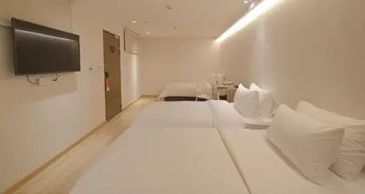 a hotel room with two beds and a flat screen tv at SimpleStay Chatuchak, SureStay Collection by Best Western in Bangkok