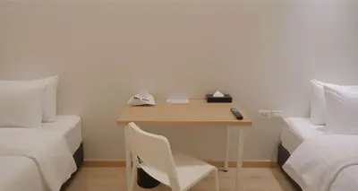 a small desk in a room with two beds at SimpleStay Chatuchak, SureStay Collection by Best Western in Bangkok