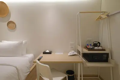 a room with a bed and a desk with a microwave at SimpleStay Chatuchak, SureStay Collection by Best Western in Bangkok