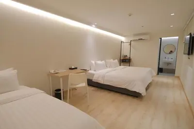 a hotel room with two beds and a desk in it at SimpleStay Chatuchak, SureStay Collection by Best Western in Bangkok