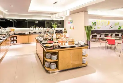 a kitchen with a counter with food on it at Boutique hotel Axis Bangkok in Bangkok