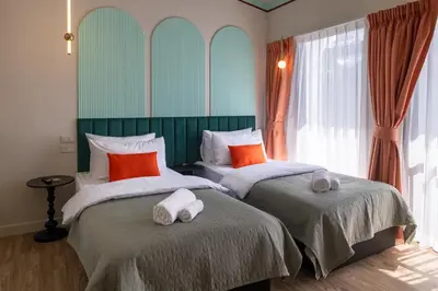 a bedroom with two beds with towels on them at Boutique hotel Axis Bangkok in Bangkok