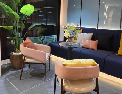 a living room with a couch and chairs and a table at Cybiq Ratchada 32 by Pikul in Bangkok