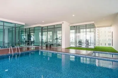 a large swimming pool in a building with windows at monthly and Annual condo in Bangkok