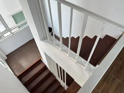 a stairway with a dog sitting on a couch at hana villa in Bangkok