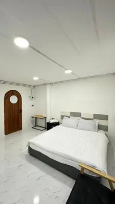 a bedroom with a large white bed in a room at Megun 10 L in Bangkok
