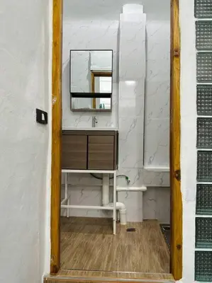 a bathroom with a sink and a mirror at Megun 10 Duplex in Bangkok