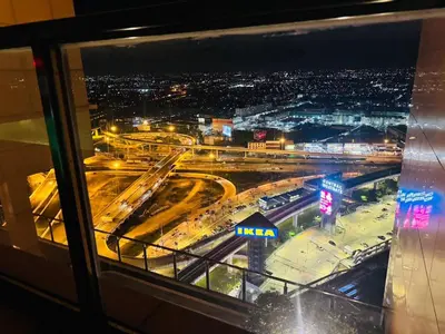 a view of a city at night from a window at 1 Bedroom Next to IKEA,Central Westgate46 in Ban Bang Krabu