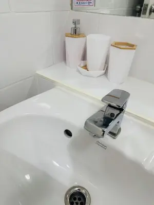 a white sink with a faucet and two toilets at 1 Bedroom Next to IKEA,Central Westgate46 in Ban Bang Krabu