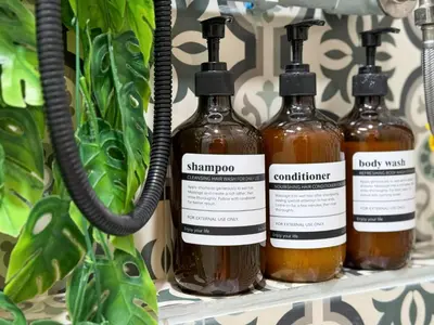 four bottles of honey on a shelf at Nordic Townhouse FIT Group - 800M MRT Huaykwang in Bangkok