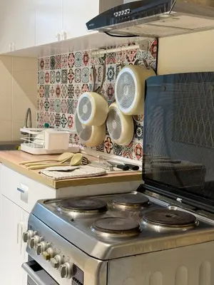 a kitchen with a stove with pots and pans at Nordic Townhouse FIT Group - 800M MRT Huaykwang in Bangkok