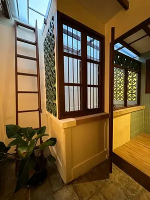 a room with a staircase and a window at The Courtesan at Yaowarat, townhome 80 Sqm in Samphanthawong