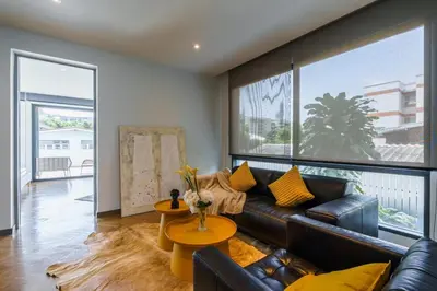 a living room with a couch and a table at Designer Pool Villa in Ekkamai in Bangkok