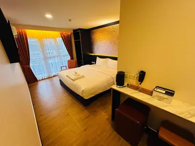 a hotel room with a bed and a desk at Emiri Hotel - Nana Bangkok in Bangkok