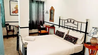 a bedroom with a black and white bed with pillows at xx The Character China Town MRT วัดมังกร in Bangkok