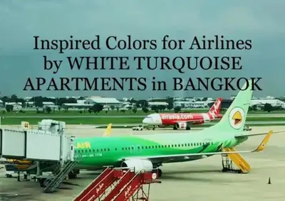 a green airplane parked on the runway at an airport at White Turquoise -2 Bedrooms Apartment- in Bangkok