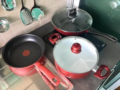 a stove top with two pots and pans on it at White Turquoise -2 Bedrooms Apartment- in Bangkok