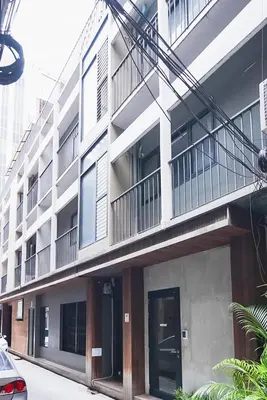 an apartment building with a balcony and a door at XX GO INN Silom Road -BTS Saint Louis in Bangkok