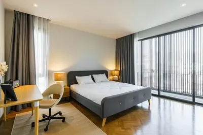 a hotel room with a bed and a desk and a desk at The Designer 49 Villa in Bangkok