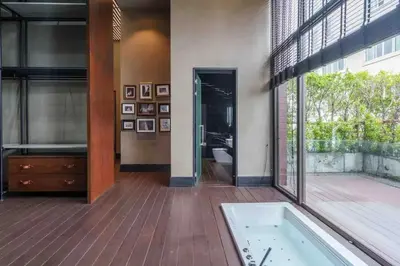 a bathroom with a bath tub and a large window at The Oasis Tranquil Escape in Bangkok