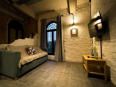 a bedroom with a bed and a large window at Cataleya Estate Boutique Bed & Breakfast in Bangkok