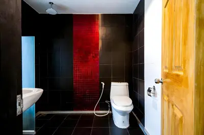 a bathroom with a white toilet and a sink at Elite Hotel Asok Sukhumvit 20 in Bangkok