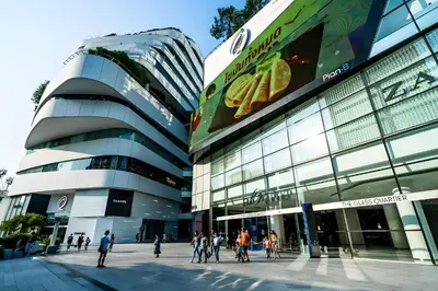 a building with people walking in front of it at Elite Hotel Asok Sukhumvit 20 in Bangkok