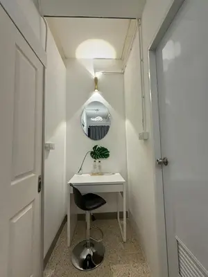 a small white desk with a chair and a mirror at Twenty Two Place Sukhumvit 22 in Bangkok