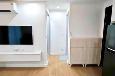 a living room with a large tv and a kitchen at 1BHK Apt High floor in Thonglor WiFi-Pool-Fitness in Bangkok