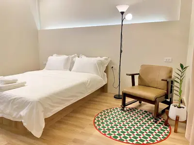 a bedroom with a bed and a chair at Cozy Corner Bangpho in Bang Su