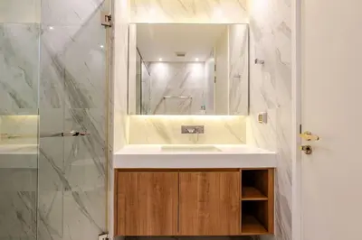 a bathroom with a white sink and a mirror at Pet Friendly Modern Nest Asoke in Bangkok