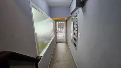 a hallway with a stairway with a window and paintings at Smile Home โรงแรม ห้องพัก รายวัน รายเดือน in Ban Zong Katiam