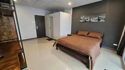 a bedroom with a bed in a room at Smile Home โรงแรม ห้องพัก รายวัน รายเดือน in Ban Zong Katiam