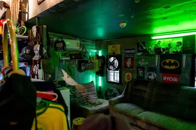 a room with a couch and a green light at Vibes Hostel Bangkok in Bangkok